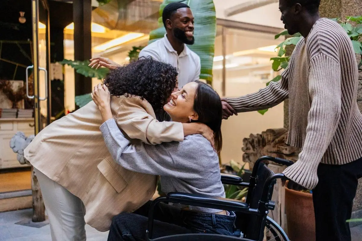 A supporter and participant sharing a warm moment